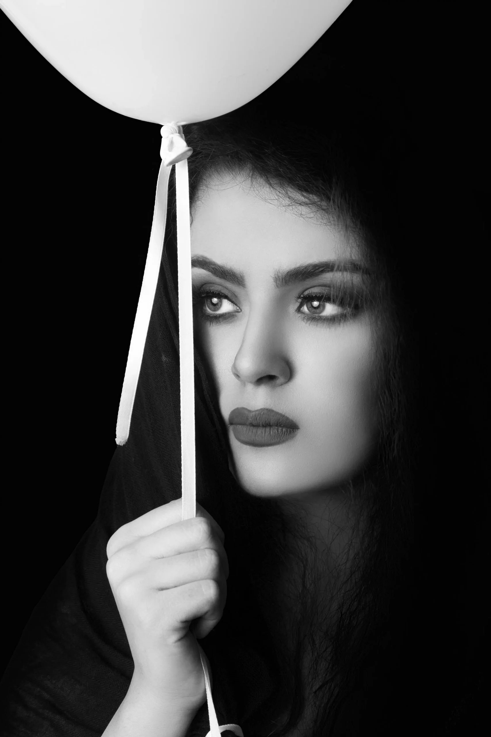 dark shooting female model with single balloon